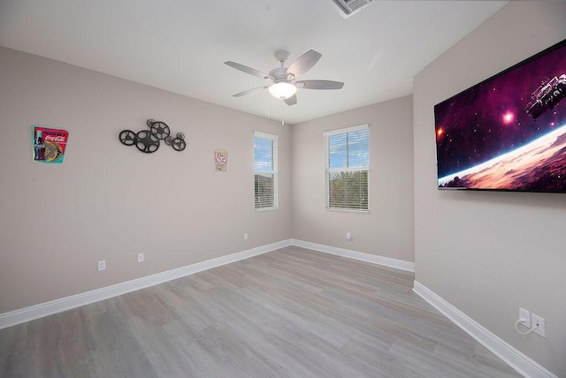 empty room featuring ceiling fan and light hardwood / wood-style flooring