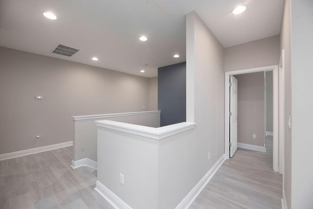 corridor with light hardwood / wood-style floors