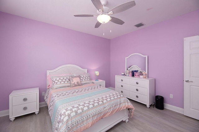 bedroom with light hardwood / wood-style floors and ceiling fan