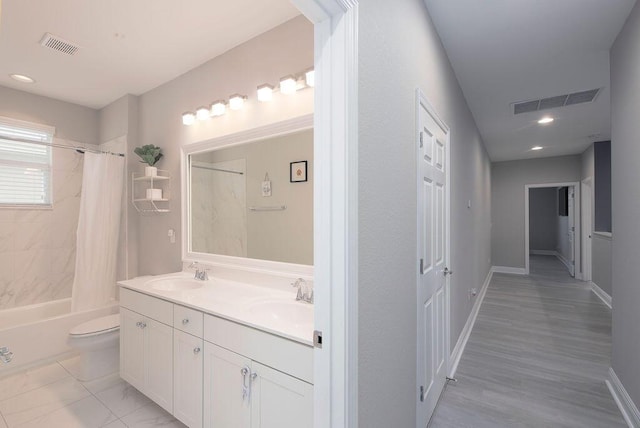 full bathroom with vanity, shower / bathtub combination with curtain, and toilet