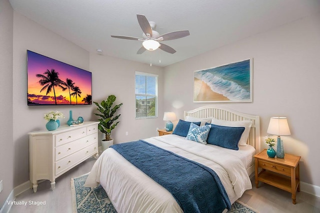 bedroom with light hardwood / wood-style flooring and ceiling fan