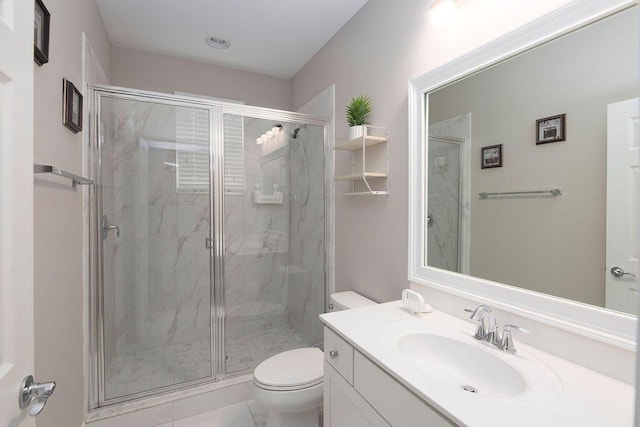 bathroom featuring vanity, toilet, and a shower with shower door