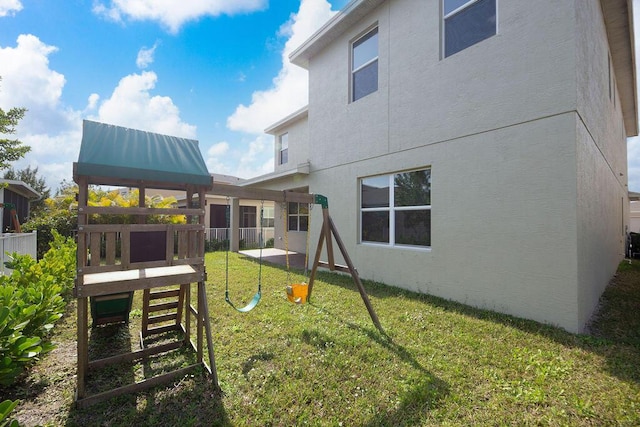 exterior space with a yard and a playground