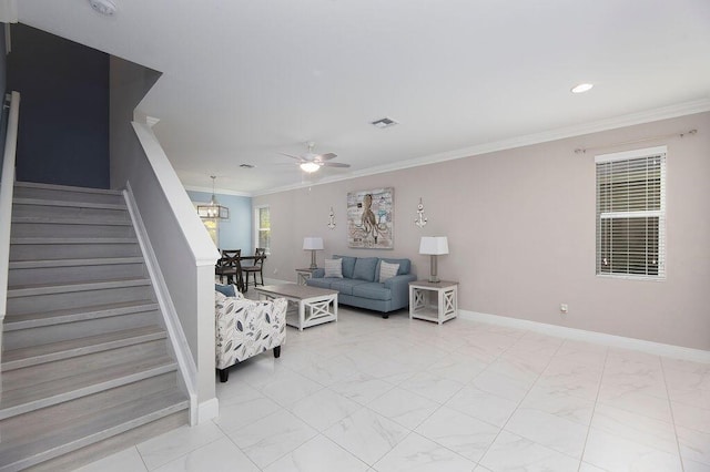 living room featuring ornamental molding and ceiling fan with notable chandelier