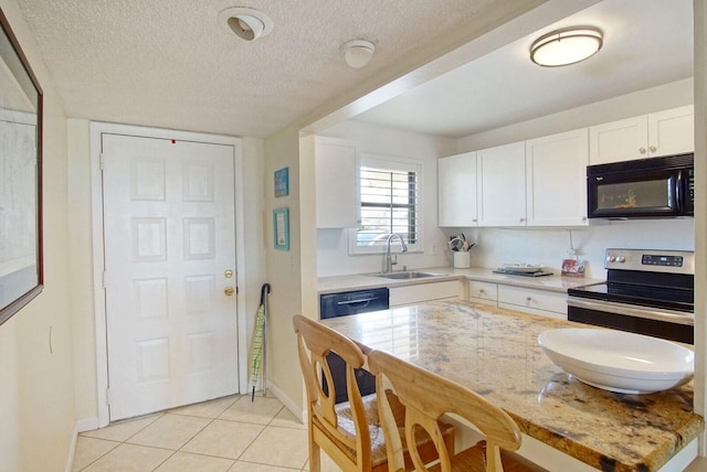 kitchen with sink, light stone counters, black appliances, a textured ceiling, and white cabinets