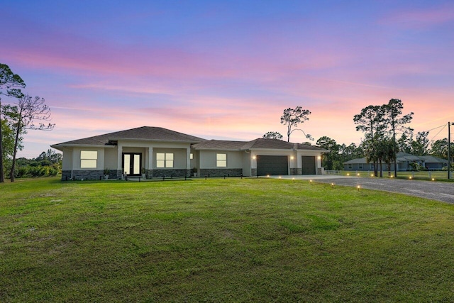 view of front of house featuring a garage and a yard