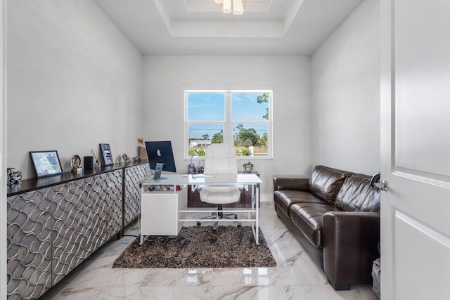 office space with a tray ceiling