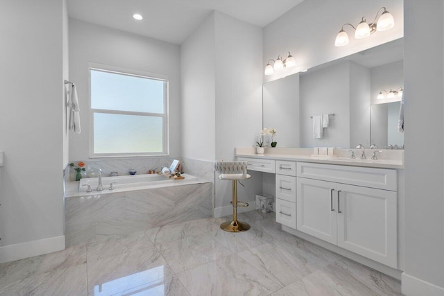 bathroom featuring vanity and tiled tub