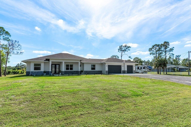 view of front of home featuring french doors, a garage, and a front lawn