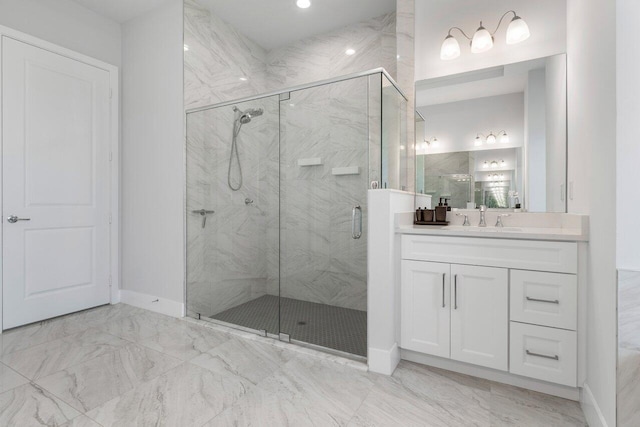 bathroom with walk in shower and vanity