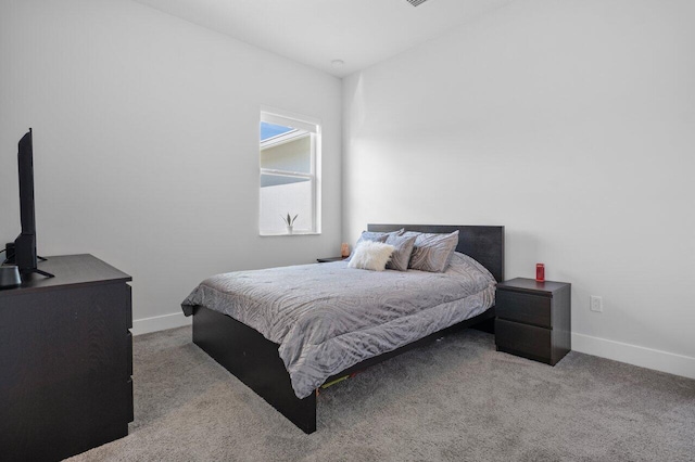 bedroom with light colored carpet