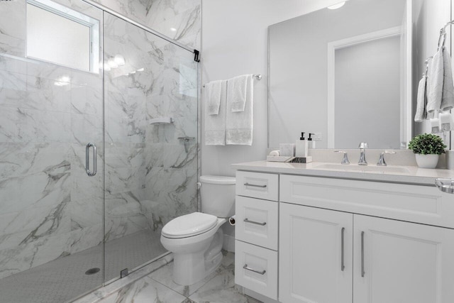 bathroom with vanity, toilet, and a shower with shower door