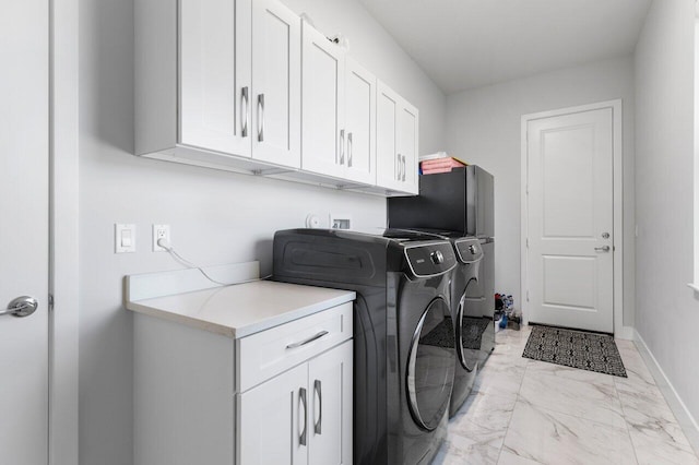 laundry room with cabinets and washing machine and dryer