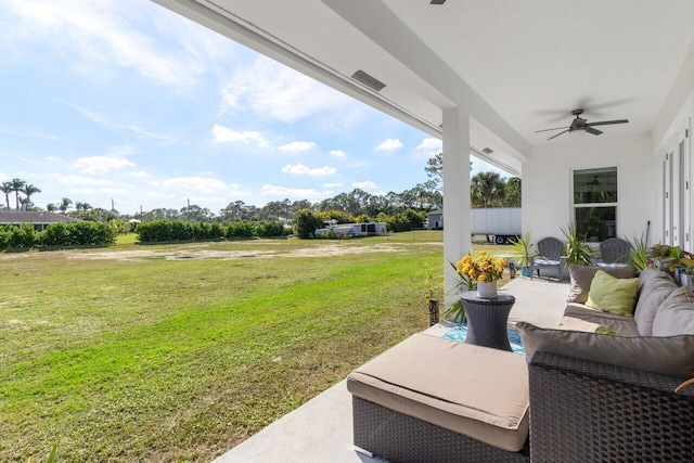 view of yard with ceiling fan, an outdoor living space, and a patio