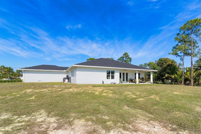 back of property featuring a yard and a patio area