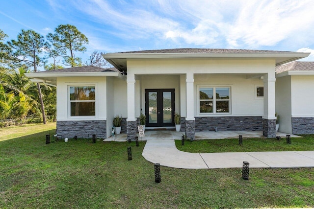 property entrance with french doors and a lawn