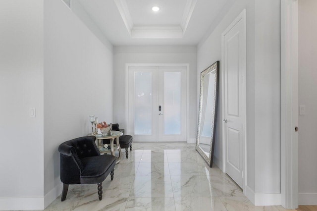 entryway with french doors, ornamental molding, and a tray ceiling