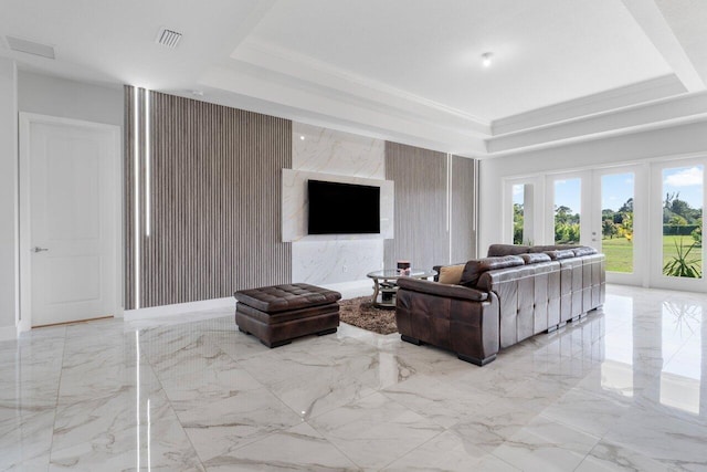 living room with a tray ceiling and french doors