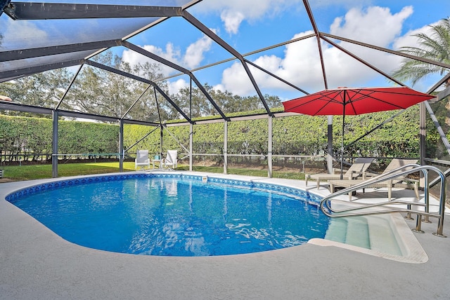 pool featuring glass enclosure and a patio