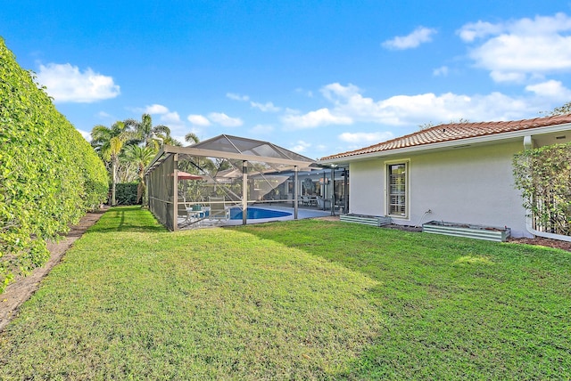 view of yard featuring glass enclosure, an outdoor pool, and a patio