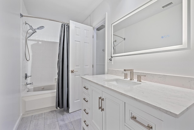 bathroom featuring shower / bath combo, vanity, and visible vents