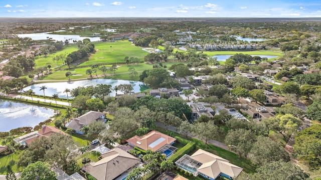 bird's eye view with golf course view, a water view, and a residential view