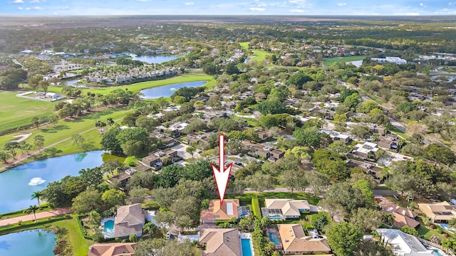 aerial view with a water view, view of golf course, and a residential view