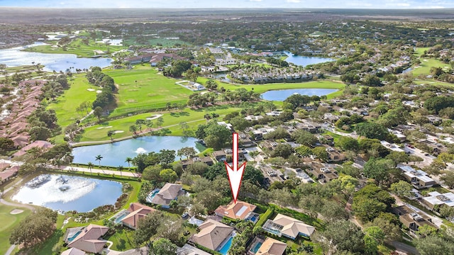 birds eye view of property with view of golf course, a water view, and a residential view