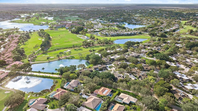 drone / aerial view with a residential view, a water view, and golf course view