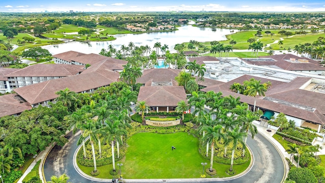 aerial view with a residential view, a water view, and golf course view