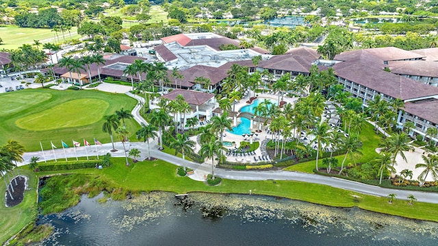 drone / aerial view featuring view of golf course and a water view