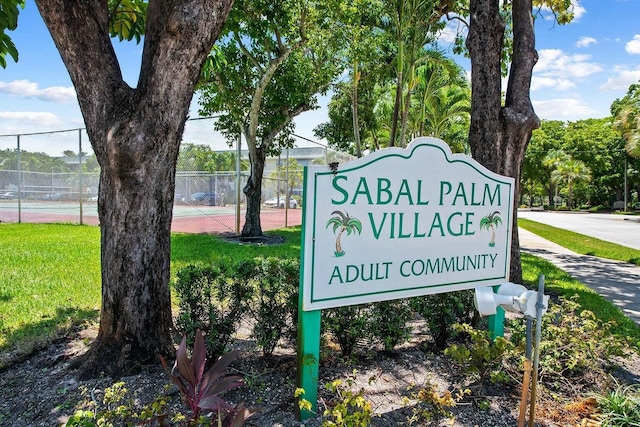 community sign featuring a lawn