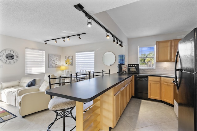 kitchen with black appliances, backsplash, light tile patterned floors, kitchen peninsula, and a textured ceiling