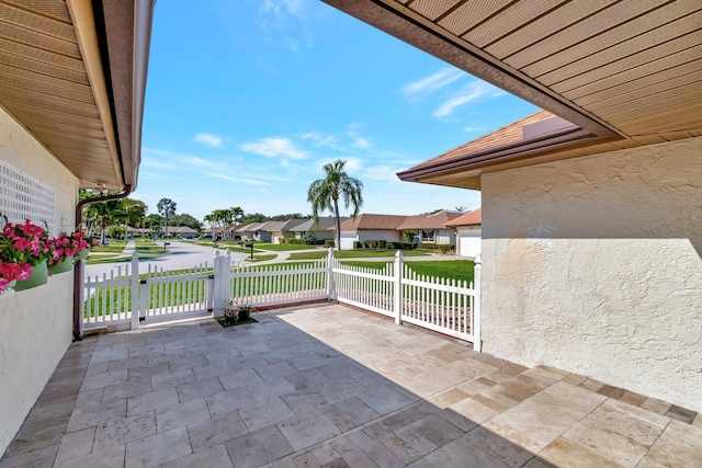 view of patio / terrace with a residential view and fence