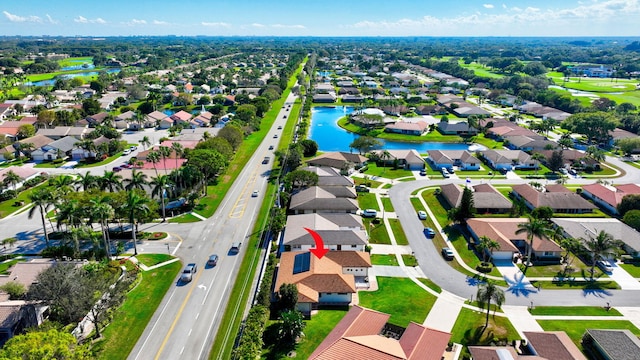 drone / aerial view with a residential view and a water view