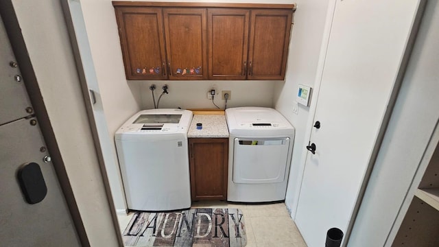 10298 Greentrail Dr N, Boynton Beach, FL 33436 - washroom featuring cabinet space, washer and dryer, and light tile patterned floors