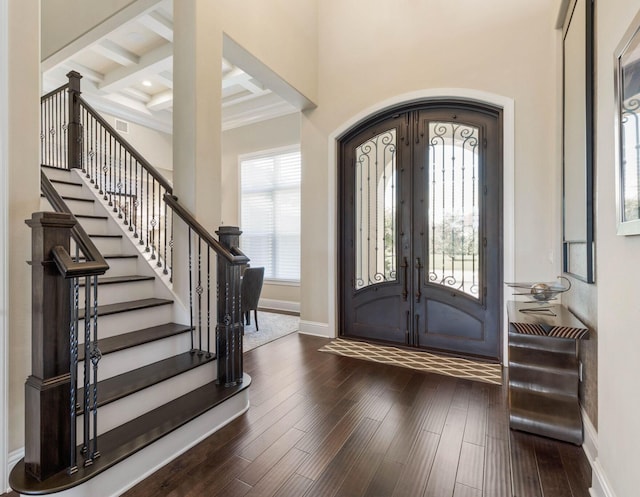 entrance foyer featuring a wealth of natural light, dark wood-type flooring, and french doors