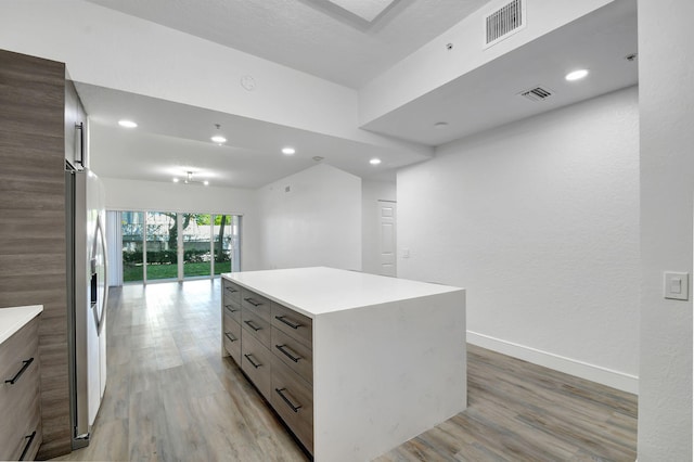 kitchen with light wood-type flooring, visible vents, and modern cabinets