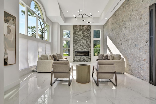 living room with a towering ceiling and a large fireplace