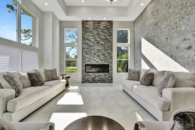 living room featuring a towering ceiling and a large fireplace