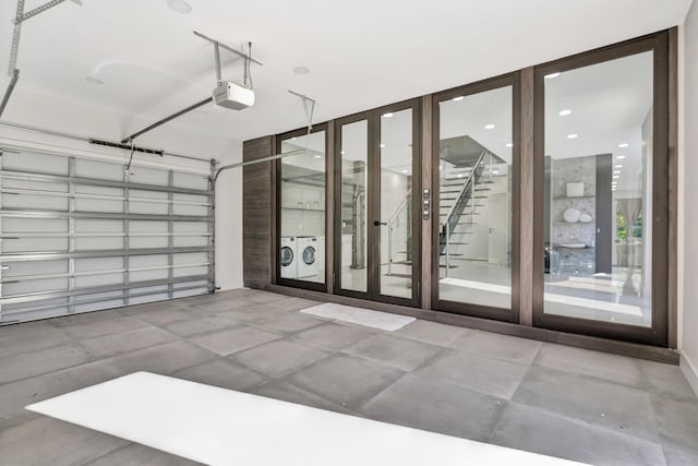 garage featuring a garage door opener and separate washer and dryer