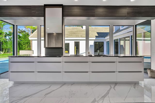 interior space featuring sink and white cabinets