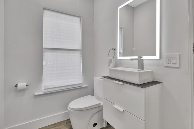 bathroom with vanity, hardwood / wood-style floors, and toilet