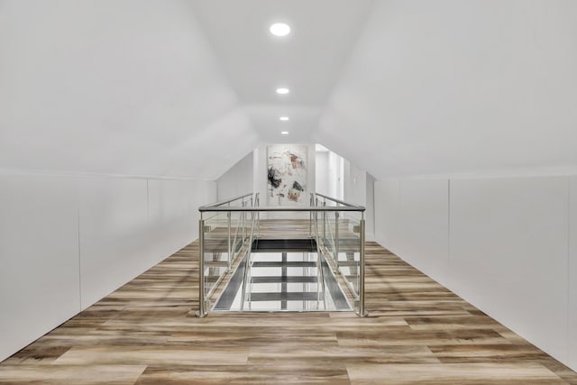 additional living space with lofted ceiling and light hardwood / wood-style floors