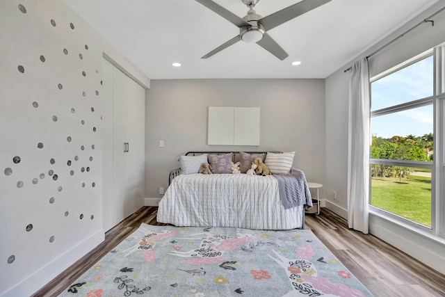 bedroom with ceiling fan and hardwood / wood-style floors