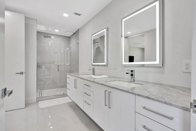 bathroom featuring vanity and a shower with shower door