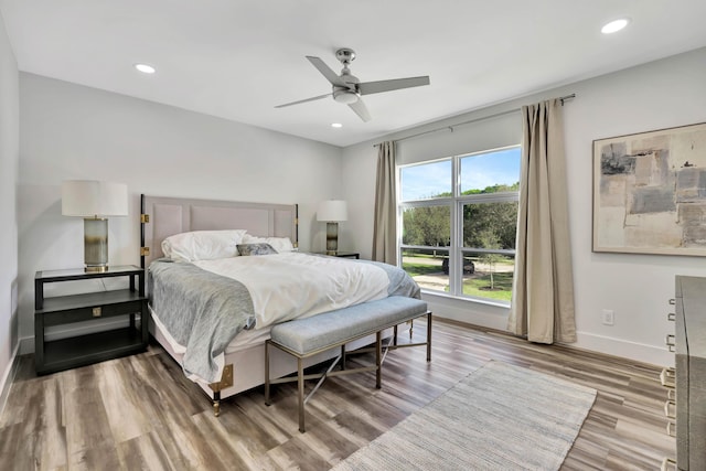 bedroom with hardwood / wood-style flooring and ceiling fan