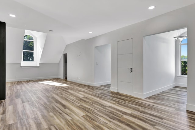 bonus room featuring lofted ceiling and light hardwood / wood-style flooring