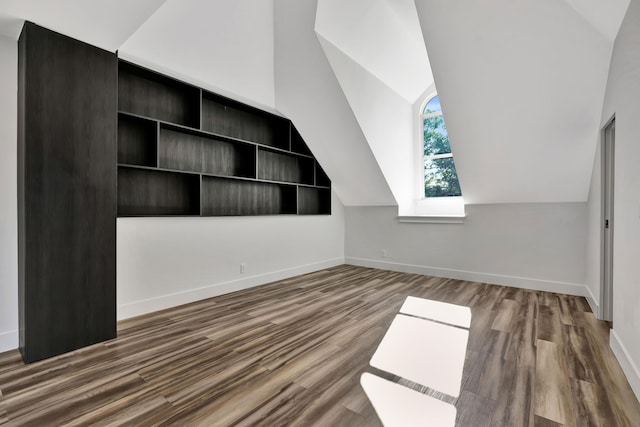 bonus room with wood-type flooring and vaulted ceiling