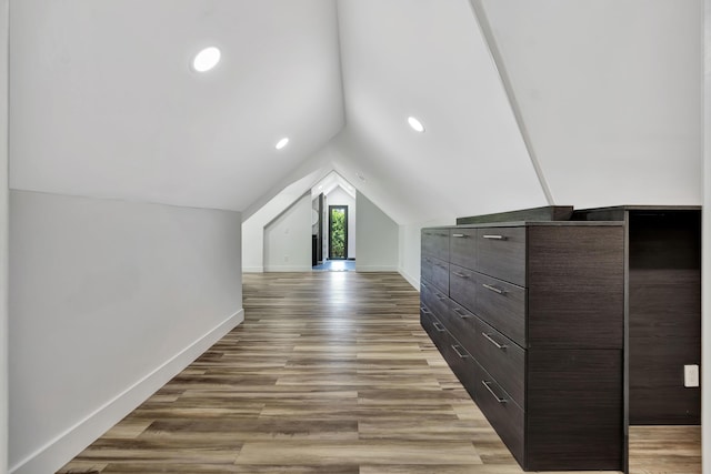 bonus room featuring lofted ceiling and wood-type flooring